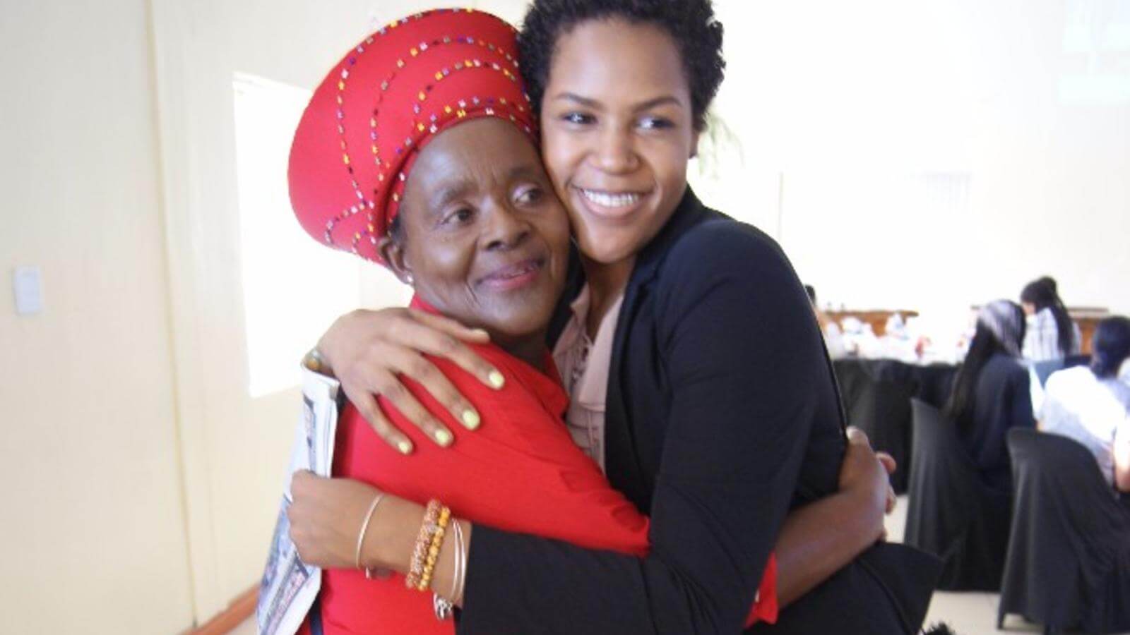 Student hugging a royal African woman