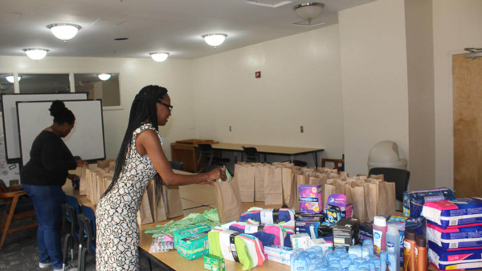 Image of woman packing a hygiene bag