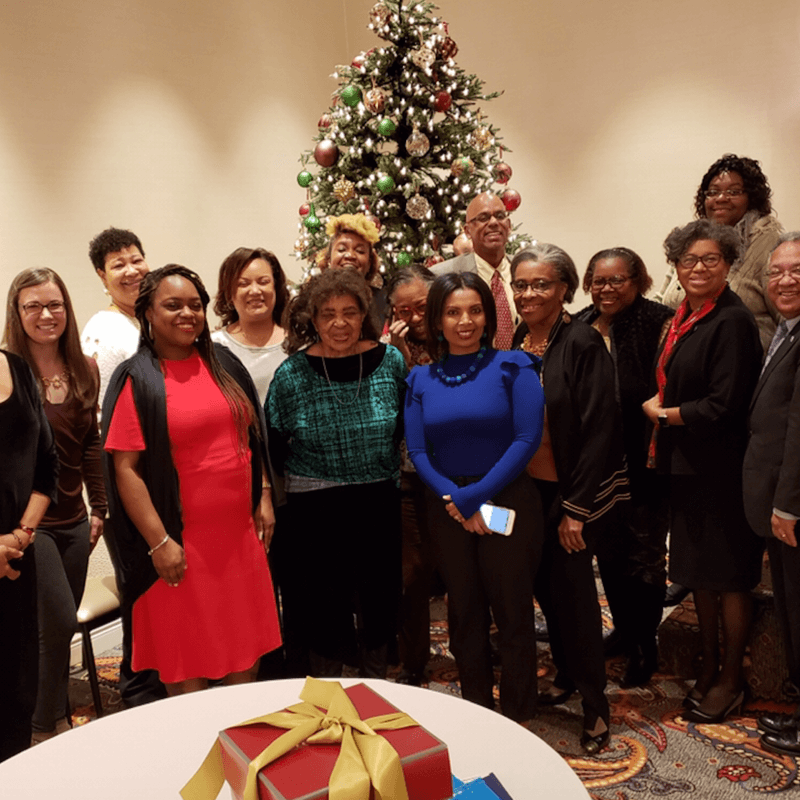 HUSSW staff stand by a Christmas tree